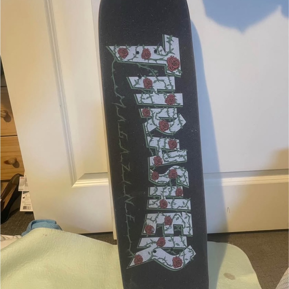 Black Skateboard with Rose Graphic